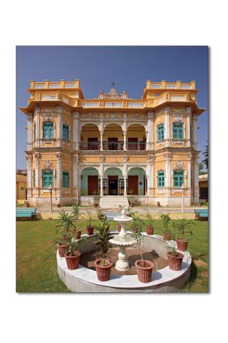 a large building with a fountain in front of it at Koolwal Kothi Zinc Journey by The Fern, Nawalgarh, Rajasthan in Nawalgarh