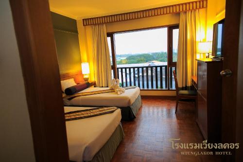 Ένα ή περισσότερα κρεβάτια σε δωμάτιο στο Wienglakor Hotel Lampang