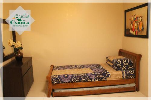 a small bedroom with a bed and a dresser at CAROLA in Pico de Loro in Nasugbu