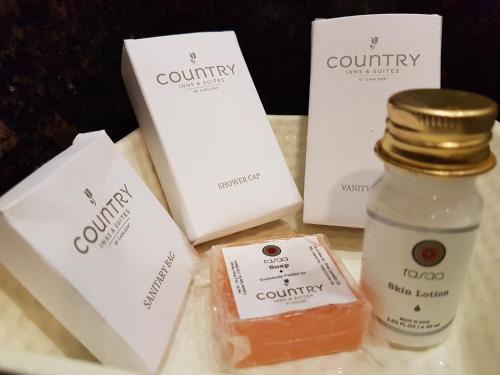 a table with a bottle of cough syrup and other products at Country Inn & Suites by Radisson, Gurugram Sector 12 in Gurgaon