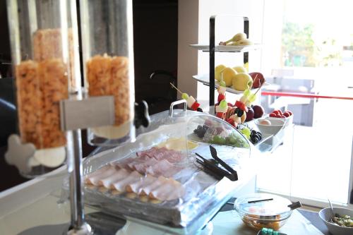 a buffet with meat and other food on a table at Hotel Sogni D'Oro Airport in Lamezia Terme