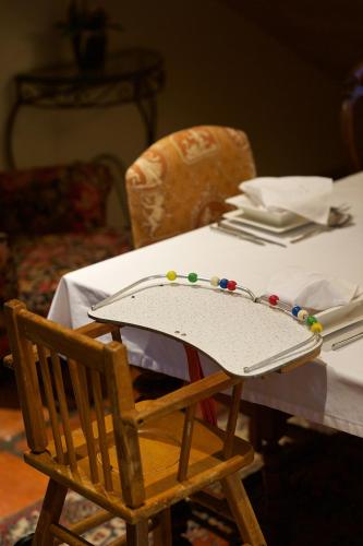 a table with a tray on top of a wooden chair at Baruch Guesthouse on Lovell in Stellenbosch
