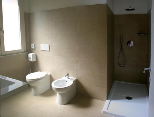 a bathroom with a toilet and a sink at Hotel Lory My Wellness SPA in Chianciano Terme