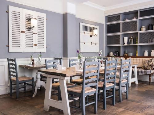 a dining room with a table and chairs at The Fleece at Cirencester in Cirencester