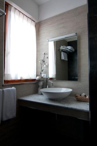 a bathroom with a white sink and a mirror at Queen Hotel in San Giovanni Teatino
