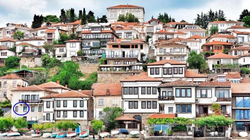 a group of houses on a hill with water at Bilyana Apartments in Ohrid