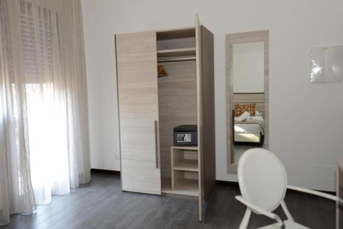 a bedroom with a mirror and a chair and a bed at BB Venice Cinzias' in Marghera