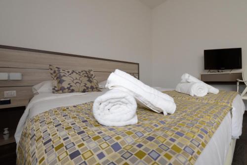 a hotel room with a bed with towels on it at BB Venice Cinzias' in Marghera