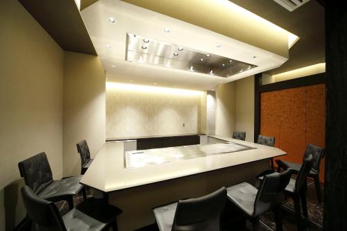 a waiting room with a counter and chairs at Piazza Hotel Nara in Nara