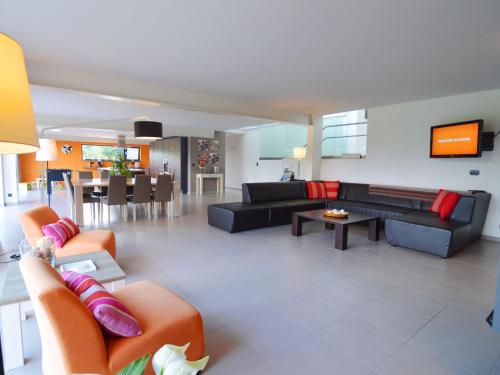 a living room with couches and a dining room at Luxurious Holiday Home in Profondeville Ardennes in Bois-de-Villers