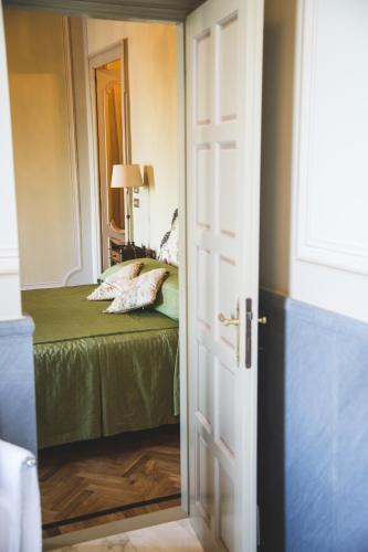 a door leading into a bedroom with a bed at Castello Di Mornico Losana in Mornico Losana