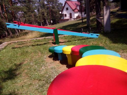 a row of colorful benches in a park at Vila Plamenac in Divčibare