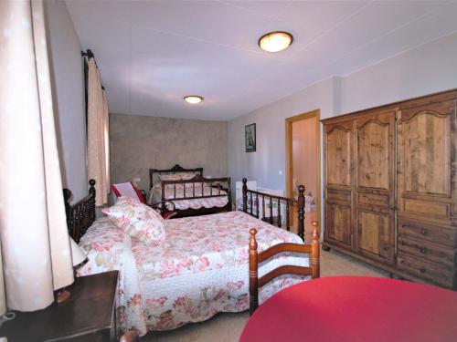 sypialnia z łóżkiem i drewnianą szafką w obiekcie Belvilla by OYO Mas Lacosta w mieście Vilasacra