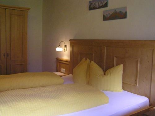 a bedroom with two beds with white sheets and pillows at Fleckhof in Neustift im Stubaital