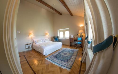 a bedroom with a bed and a table and chairs at Castello Di Mornico Losana in Mornico Losana