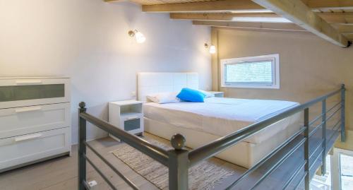 a small bedroom with a bed and a staircase at Camping Valti Houses in Sarti