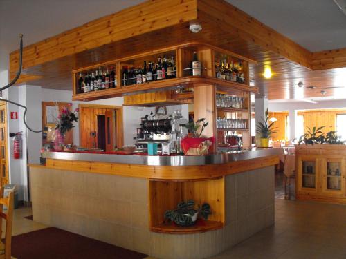 a bar in a restaurant with a counter top at Hotel Valdotain in Villeneuve