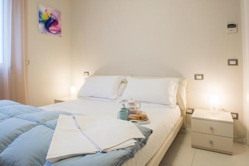 a bedroom with two beds and a plate of food at Residence Millecento in Cesenatico