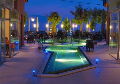 a swimming pool in the middle of a patio at night at Thalassa in Loutra Edipsou