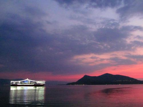 a cruise ship on the water at sunset at Thalassa in Loutra Edipsou