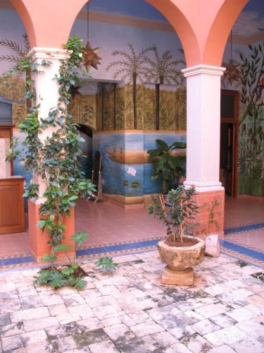 a courtyard with a pool in a building at Hotel Boutique Casa San Angel in Mérida