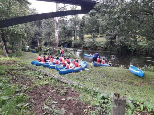 a group of people in kayaks on a river at Apartamentos Los Castros in San Tirso de Abres