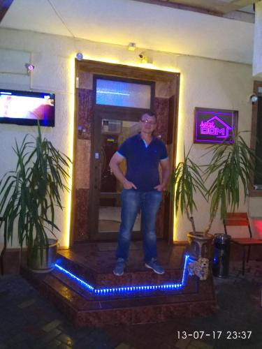 a man standing in the doorway of a room at ApartHotel Dom in Odesa