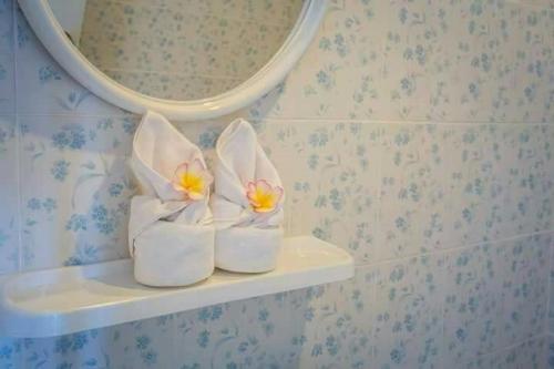 a pair of white shoes sitting on a shelf in a bathroom at Home Rezidence Prachinburi in Si Maha Phot
