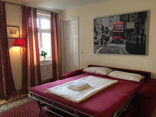 a bedroom with a red bed with a double decker bus at Apartment am Rathaus Potsdam-Babelsberg in Potsdam