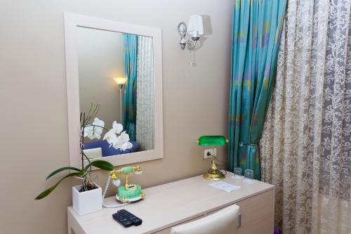 a bathroom with a vanity with a mirror and a shower curtain at Classes Boutique Hotel in Istanbul
