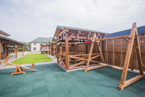 a deck with a wooden pavilion on a house at Praktik Hotel & Restaurant in Berehove