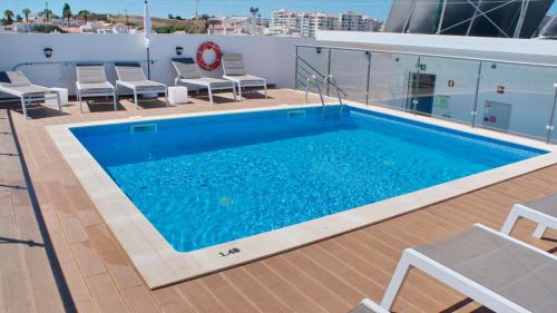 a swimming pool on the roof of a building at Topcity Hostel & Suites in Lagos