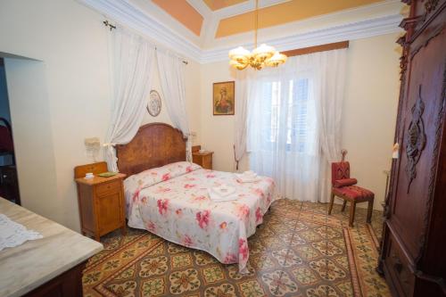 a bedroom with a bed and a chair and a window at Giulia e Pietro - Marettimo Apartments in Marettimo
