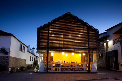 a building with a table in the middle of a street at A. Montesinho Turismo in Bragança