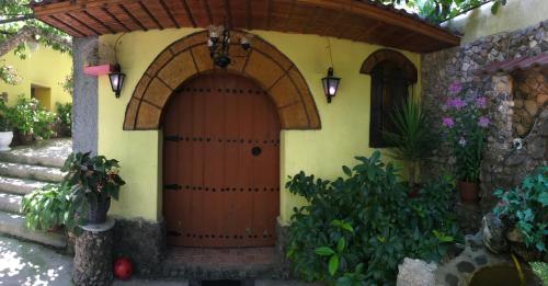 an entry to a house with a wooden door at Karafil Guesthouse in Gjirokastër