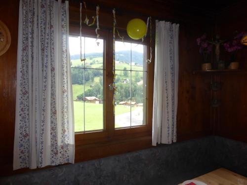a window with a view of a green field at Schwaighof in Oberau