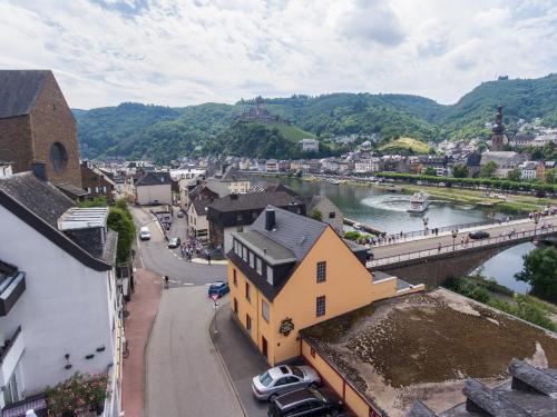 a view of a town with a river and a bridge at Hotel Traumblick in Cochem