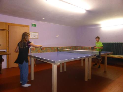 two people playing a game of ping pong at Schwaighof in Oberau