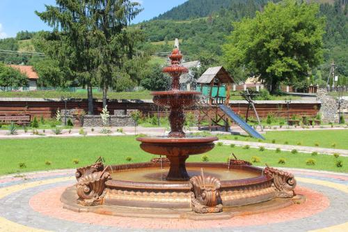 a fountain in the middle of a park at Hotel Duet in Maydan