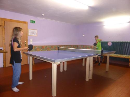 two people playing a game of ping pong at Schwaighof in Oberau
