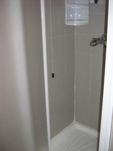 a shower with a glass door in a bathroom at Hostiliae Ciminiera Hotel in Ostiglia