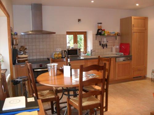 a kitchen with a wooden table and a table and chairs at Vergecosse in Vergisson