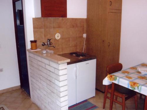 a small kitchen with a sink and a table at Studio Apartment Pula near Sea 2 in Pješčana Uvala 