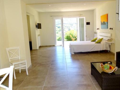 a bedroom with a bed and a couch and a table at Hotel Santo Stefano in Portoferraio