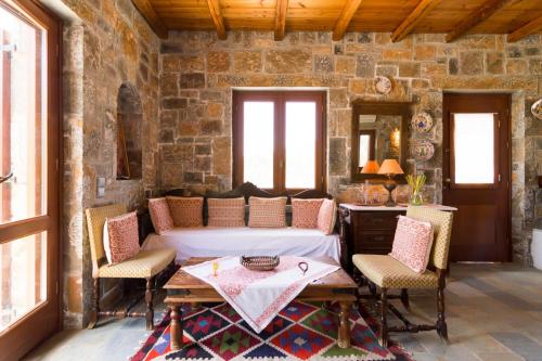a room with a bed and a table and chairs at Athena Villas Olive Grove & Estate in Gouves