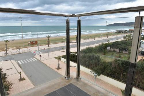 a view of a beach from a room with a window at Bellington Appart Hôtel in Saïdia