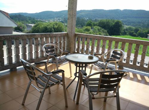 a table and chairs on a balcony with a view at Hostal - Restaurante Casa Cuña in Tebra