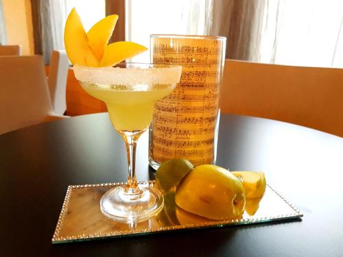 a drink on a table with lemons and a glass at Style Hotel Grifone in Madonna di Campiglio