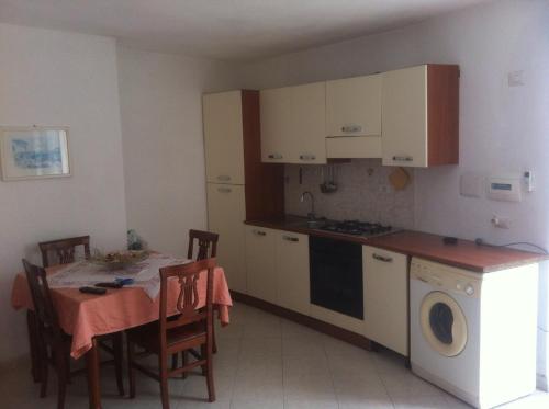 a kitchen with a table and a kitchen with a washing machine at Casa vacanza in Ponza