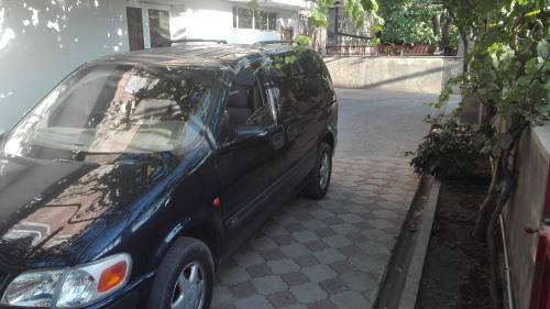 a black car parked on the side of a street at Karine B&B in Yeghegnadzor